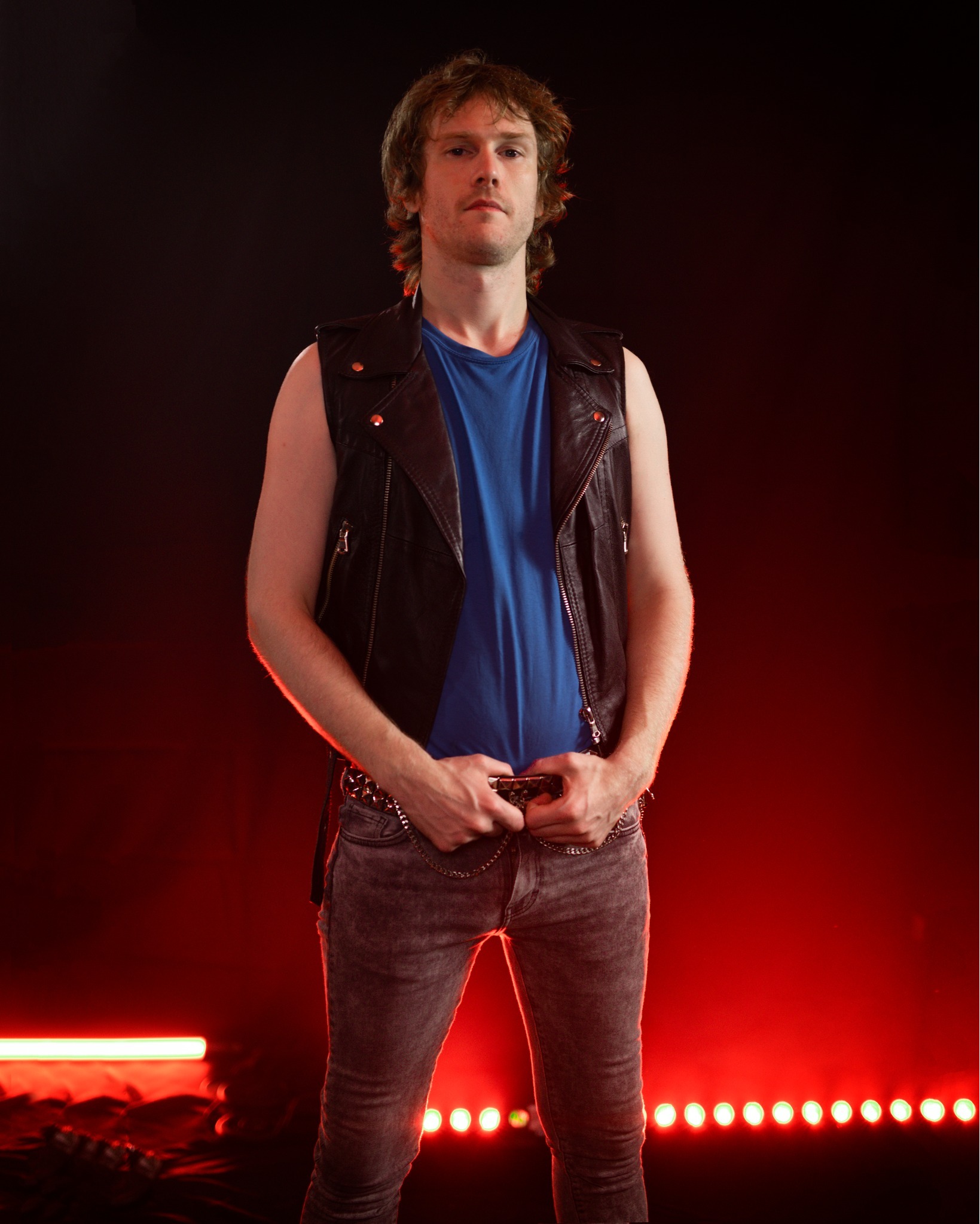 Cederick Forsberg, Swedish guitarist of the heavy metal band Bronze. Studio photo with red stage lights, taken by Emil Westin and edited by Mina Walkure for the Realm of the Damned photoshoot session.